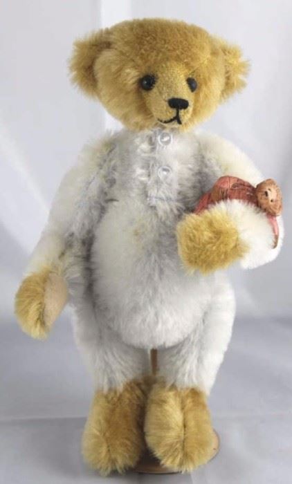 Michael Jonathan-243. Steve Schutt-Bear -  "S"-ence. In mohair-it, beige & baby blue standing  at 10" H in excellent condition. 1992 Disney Land  Convention-Teddy Bear Classic. Wears baby blue  mohair pajamas with small white buttons. 
