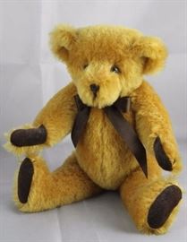 Baby - 42. Bedford Bears, England in gold mohair.  10.25" H in excellent condition.  Artist: Edwin  Richard-Owen. Tied with brown satin ribbon (red  ribbon) around neck.
