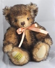 Aprico-270, Merrythought-England in mohair tipped  apricot.  Ironbridge bear with cream flannel paw  pads.  Has a peach ribbon neck bow.  Ltd. #0540 of  1000. Size:  10" H
