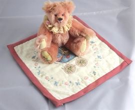 Patti-cakes-271. Sherry Dodson, We three bears.  Mohair-pink from 1990. 6.75" H in excellent  condition. Pinkish cream lace ruff with pink  favric flower around neck.  Baby bear is in the  center of a small 8.5" square quilted blanket
