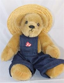 Jimmy - 37. 1990 Sue Spencer Chaffee - S. C.  Origin. Mohair-golden in excellent condition. 10"  H in excellent condition.  A 'Reversing Faces'  (sleep/wake) bear is pellet filled.  Dressed in  jean overalls with a pocket bandana and straw hat.
