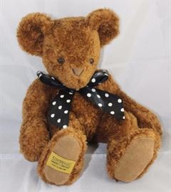 Curly Bean Bear-98, Merrythought-England.  Bear in  lamb (distressed persian) brown.  Trademark tag  across bottom pad.  Jtd. brown bear with black and  white polka dot ribbon neck bow.  Ltd. #126 of  500.
