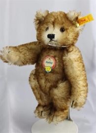 Steiff Teddy Bear - Petsy Mini-99 Mohair-cream/flannel-light tan.  Jtd. cream mohair  tipped paprika brown bear with light tan flannel  paw pads.  Wears a yellow elephant historic chest  tag, "Petsy".
