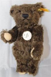 Steiff Teddy Bear - Teddy (1920) Mini-361 Mohair-brown/flannel-cream.  Jtd. long distressed  dark brown mohair bear with cream flannel paw  pads.  Wears white historic chest tag, "Teddy  1920".
