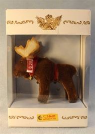 North American Exclusive.  A brown mohair moose  with felt air-brushed antlers.  A red velvet  ribbon around it's neck with hanging round brass  bells.  Ltd. #0207 of 2005. Size:  5" H
