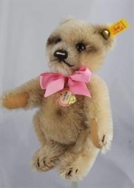 Steiff Teddy Bear - Jackie (1953) Mini-104 Mohair-honey/flannel-cram.  Jtd. honey mohair bear  with cream flannel paw pads and small black air  brushed areas.  Wears yellow elephant historic  chest tag, "Jackie 1953".  With a pink ribbon neck
