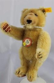 Steiff Teddy Bear - Dickey (1930) Mini-105 Mohair-blond/felt-peach.  Jtd blond mohair bear  with two colored air-brushed peach felt paw pads.   Wears a yellow elephant historic chest tag,  "Dicky 1930".
