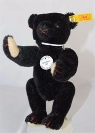 Steiff Teddy Bear - Black Bear Mini- 103 Mohair-black/flannel-it. tan.  Jtd. black mohair,  light tan flannel paw pads with red thread.  Wears  white historic chest tag, "Schwarzbar". Size:  6" H
