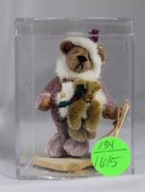 Little Gem Teddy Bear - Alexandra (Xmas) Mini-521 In the box, velvet plush-lavender/beige.  1995  Christmas (pairs with Nicholas) comes in acrylic  box, with tag and wooden heart stand.  Small bear  with  white faux fur around neck.  
