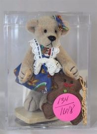 Little Gem Teddy Bear - Gretal & Ginger (Xmas)  Mini-523 In the box, velvet plush-It. beige.  1995  Christmas (pairs with Hansel) comes in clear  acrylic box, with tag, and wooden heart stand.   Small bear wears a blue print head bow and dress
