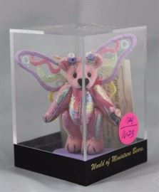 World of Mini Teddy Bear - Flutterfly Mini-826 In  the box, velvet-shades of pink.  This World of  Miniature edition is Ltd. to 2000 pcs.  The artist  is Tina Richardson.  This small velvet pink-toned  bear is a butterfly with shimmering embroidered wings
