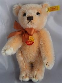 Teddy Holland 1955-345 Bow Tie Pink Bear.  Wears a  salmon ribbon neck bow.  Has a historic half red,  half yellow chest tag. Size:  6.25" H Excellent condition.

