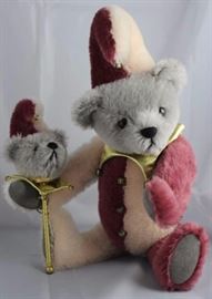 Bearoretto-198.  Gray Jester bear with a a rose &  pink body suit.  Gold metallic capelet with jingle  bells, holds a matching jester stick.  A rose and  pink mohair curled jester cap with jingle bell on  end.  Ltd. #2 of 20.
