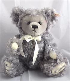 Sea Bear-703 Gray Bear.  WDW-1988 Teddy Bear and  Doll Convention.  Has a shaved face with a cream  ribbon neck bow.  On the bottom of his cream  flannet paw pads is an embroidered anchor and  1998.  It is signed by JR Junginger (grand nephew)
