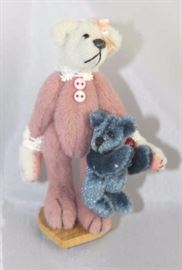 Amelia (w/bear purse)-229 Pink Bear.  Friends  Collection from Little Gem Teddy Bear.  Bear in a  pink body suit carries a blue bear purse while  standing on a small heart stand. Size:  3" H
