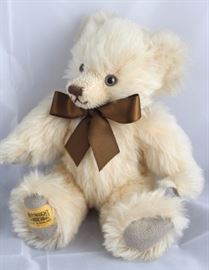 Cottridge-249, Merrythought-England in apricot  mohair, grey suede.  Has a brown ribbon neck bow. Size:  10" H Excellent condition.
