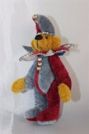 Jester Blue-199.  This Little Gem Teddy Bear  edition.  Burgundy/silver blue suit with matching  cap.  Wears a neckline ruffle. Size:  3" H Excellent condition.
