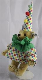 Steiff - Circus Clown Driver-183 in the box.   Checked cone hat with red, green, yellow, and blue  pom poms.  Green ruffle around neck.  Teddy Clown  Junior.  Ltd. to 5000. Size:  6" H
