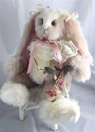 Periwinkle (rabbit)-205 Pink Rabbit.  Tumble  Bears.  Stuffed with pellets.  White lace collar  tied around neck with a rose ribbon bow.  The ears  are pink suede inside and tied with white and  pink lace bows.  Holds a deep rose garland.  
