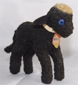 Steiff Swapl Lamb-316 Black Lamb.  R.B. and C.P.  original ribbon (faded cream ribbon bow).  Yellow  elephant chest tag "SWAPL".  Light top knot.  Has  an ear button with missing ear tag. Size:  4 1/2" H
