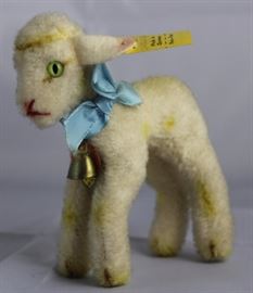 Lamby (lamb)-134 Yellow Lamb.  Has light green  eyes with a blue ribbon neck bow and small brass  bell. Size:  4" H Excellent condition.
