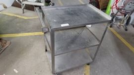 Stainless bus cart on wheels.