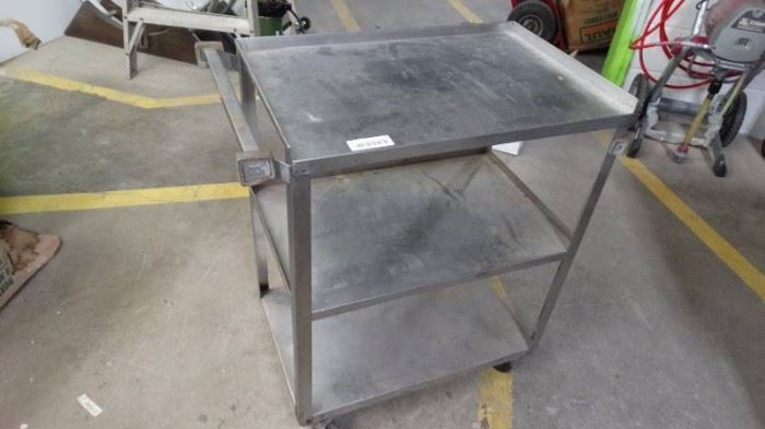 Stainless bus cart on wheels.