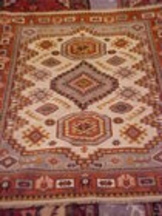 Several various colors & sizes Persian rugs.