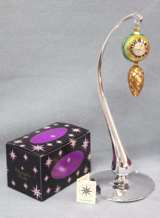 Christopher Radko "Time to Spare" Christmas  ornament.  hand blown and hand painted.  Designer  glass ornaments made in Poland, Germany, Italy, or  Czech Republic.  Stand not included. Size:  5" H x 2" W
