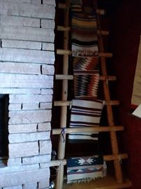 Collection of Indian rugs on wooden ladder