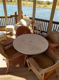 Stone top table on a metal base, there are six of the wicker armchairs