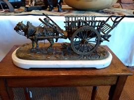 Beautiful antique bronze wagon with horse on white marble plinth setting on the perfect mahogany stand