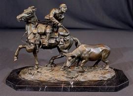 301a  Bronze cowboy herding cows, signed GI Gratcheff, 10 in. T, 15 in. W, 6 in. Dia.