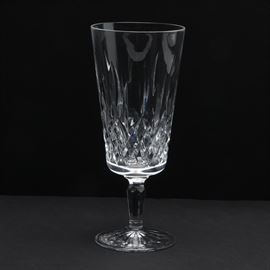 Waterford Crystal "Lismore" Glass Signed by Master Artisan: A Waterford crystal “Lismore” wine glass. Glass is presented in the Lismore pattern of crossing diamond cut design with a fluted bowl, and a faceted stem. The base is circular with a starburst design and is etched to its underside “Waterford” and signed by Master Artisan Fred Curtis and dated 5-8-99.