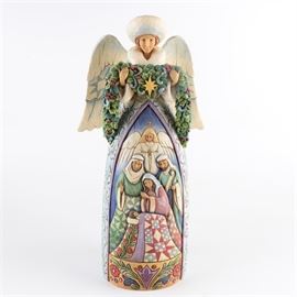 Jim Shore "Night Divine" Nativity Angel Statue: A resin statue by Jim Shore. Titled Night Divine this depicts a winged angel dressed in white winter furs holding an evergreen swag. There is a nativity scene in shallow relief in the front. It retains its original label underneath.