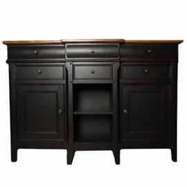 Thomasville Farmhouse Style Sideboard: A contemporary farmhouse style sideboard from Thomasville Furniture. This large piece has a thick pine top over a painted black wood cabinet featuring six storage drawers over two cabinets with paneled doors and open storage to the center. It has aged metal pulls, flatware storage, and stands on tapered legs. Marked Thomasville to the interior of the drawer.