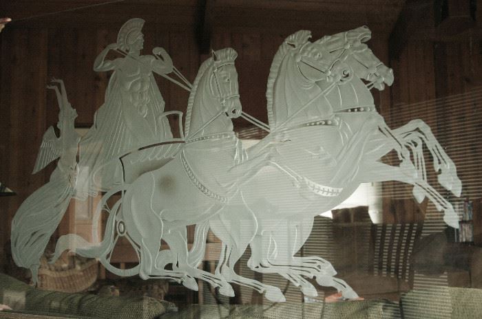 The size is of the art piece is 31.75'' x 54.25''x .5''. It was designed by Jay Tyson, a well known, trend setting New York City interior designer back in the 50' and 60's. The piece is timeless with a horse and chariot theme. I have also heard that this could be a depiction of Elijah with the heaven sent horse and chariot as Elijah never died. The piece is not dated or signed. The 1/2'' thick glass is clear. For presentation it was lit with fluorescent light tubes from the top and bottom. Pictured are a full shot and two close-ups to show the high level of detail and craftsmanship. Two artists in the sand carving business said others in the business would charge between $15,000-$20,000 for this work. For long distance shipping, a case would have to be constructed based on distance to ship and carrier charges. The main photo is a mock up of what the piece would look like as part of an aquarium display. $1700  OBO