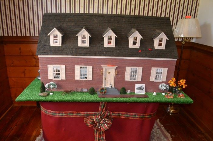Large Cape Cod style dollhouse (48”w x 28”h x 24”d), modeled after owner's office in Colonial Heights; rear and back half of roof are removable; includes all outdoor shrubbery and other miniature objects, platform and stand (60”w x 29”h x 36”d), lights
LOT 207