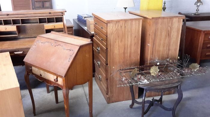 Desks, chests of drawers, mid-century metal wall decoration.