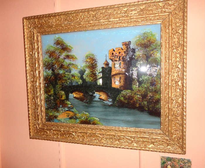 Attractive reverse painting of castle scene in decorative frame.