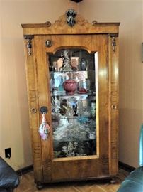 Beidermeier cabinet with glass panel in door.