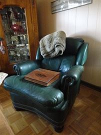 Dark green leather armchair - small tear on cushion but  could be repaired or re-covered.