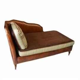 Victorian Style Chaise Lounge: A Victorian style chaise lounge. This lounge features a rectangular cushion seat that rises above an apron with nailhead trim and terminates on tapered legs. The chaise is unmarked.
