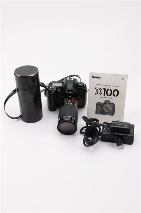Nikon D100 Camera and Accessories: A Nikon D100 dSLR camera, with a Nikon F-mount for lenses, a Nikon DX format sensor, 6.0 megapixels of maximum resolution, CAM 900 focus with standard Nikon AF modes, 10 segment exposure metering, vertical-travel focal-plane shutter, 1.8" LCD monitor and comes with a Rokinon 1:4 f=75-200 mm lens, owner’s manual, lens case and battery charger with power cord.