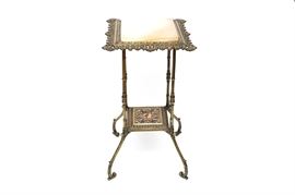 Rococo-Style Plant Stand: A Rococo-style stone and brass plant stand. The square stone top is set to a reticulated frame featuring a low shelf supported by spider legs terminating in scroll feet. It appears to be made of a cast metal with a brass finish.