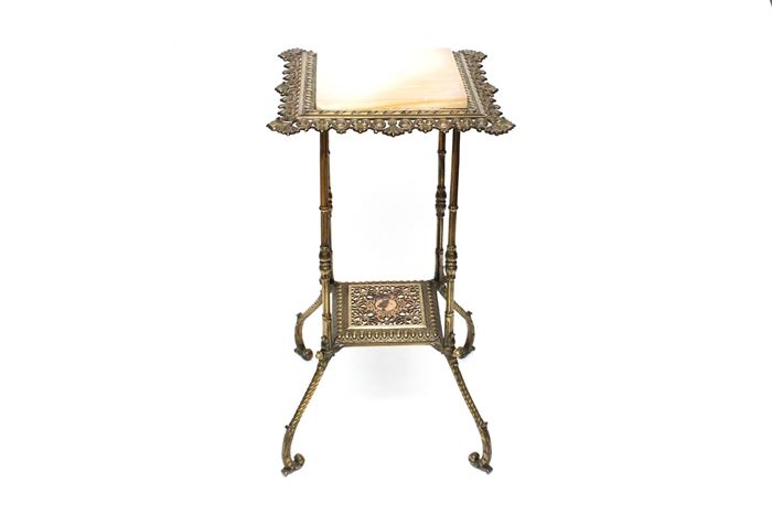 Rococo-Style Plant Stand: A Rococo-style stone and brass plant stand. The square stone top is set to a reticulated frame featuring a low shelf supported by spider legs terminating in scroll feet. It appears to be made of a cast metal with a brass finish.