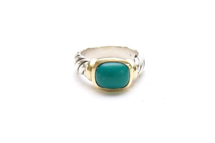 David Yurman Sterling and 14K Gold Ring With Reconstituted Turquoise Cabochon: A David Yurman sterling ring with 14K yellow gold mount and a cushion cabochon reconstituted turquoise.