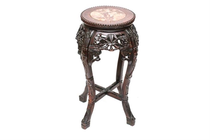 Antique Carved Rosewood Jardiniere Stand: A Chinese early 20th century carved rosewood jardiniere stand. This small table features a round stone slab inset to a beaded-edge top, a heavily carved reticulated apron, and cabriole legs with a low x-stretcher.