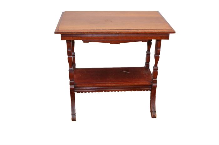 Vintage Occasional Table: A vintage occasional table having an ogee edged top, reeded accents to the apron, and shaped legs with fluted detail to flared feet. A lower shelf features a scalloped apron. This item is made of hardwoods and veneers and finished to all sides. It is unmarked.