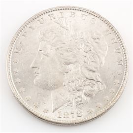 1878 7 Tail Feathers Silver Morgan Dollar: An 1878 7 Tail Feathers silver Morgan dollar. Designer: George T. Morgan. Mintage: 9,759,300. Metal content: 90% silver, 10% copper. Diameter: 38.1 mm. Weight: approximately 26.7 grams. The coin is in very good condition.